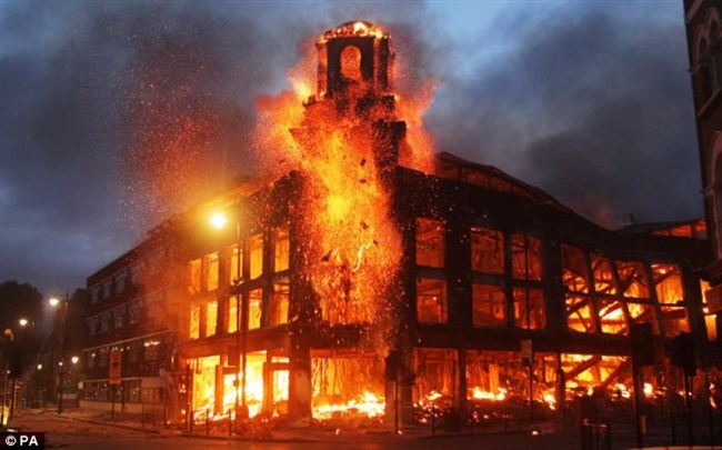 InfernoFlames rages through the Allied Carpets building Tottenham Saturday night  with fire crews prevented from tackling case they were attacked rioters