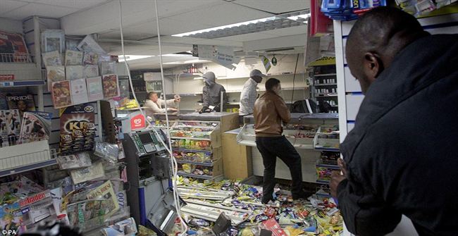 Rampagegroup looters raid local shop Hackney  stripping the shelves bare drink and cigarettes  while cash machine also ripped apart